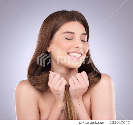 Woman, smile and strong haircare in studio, background and growth results, shine or keratin treatment. Happy female model, long hairstyle and smooth textures for balayage, beauty or shampoo cosmetics Woman, smile and strong haircare in studio, background and growth results, shine or keratin treatment. Happy female model, long hairstyle and smooth textures for balayage, beauty or shampoo cosmetics 133017645