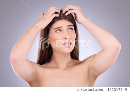 Woman, hair and worried of scalp dandruff on studio background to scratch allergy, eczema or head lice. Female model, itching scalp and haircare problem of damaged texture, dry skincare or dermatitis Woman, hair and worried of scalp dandruff on studio background to scratch allergy, eczema or head lice. Female model, itching scalp and haircare problem of damaged texture, dry skincare or dermatitis 133017649