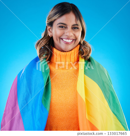 Portrait, pride and woman with rainbow flag, queer and acceptance against a blue studio background. Face, female and happy girl with symbol for lgbtq community, equality and transgender with support Portrait, pride and woman with rainbow flag, queer and acceptance against a blue studio background. Face, female and happy girl with symbol for lgbtq community, equality and transgender with support 133017665
