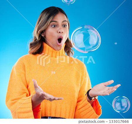 Surprise, shock and bubble with indian woman in studio for soap, positive and satisfaction. Magic, creative and holding with female isolated on blue background for bright, cute and entertainment Surprise, shock and bubble with indian woman in studio for soap, positive and satisfaction. Magic, creative and holding with female isolated on blue background for bright, cute and entertainment 133017666