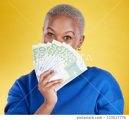 Money winner, portrait and black woman with euros in studio isolated on a yellow background. Financial freedom, wealth and face of rich female with cash after winning lottery, prize or competition. 133017776
