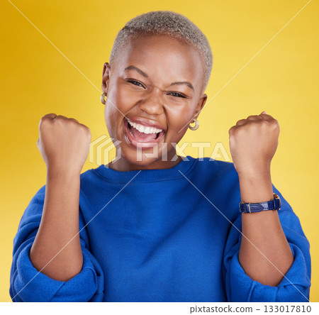 Portrait, happy black woman and fist of winner in studio for celebration, achievement deal and success. Excited female model celebrate winning prize on background for lottery, bonus victory and smile Portrait, happy black woman and fist of winner in studio for celebration, achievement deal and success. Excited female model celebrate winning prize on background for lottery, bonus victory and smile 133017810