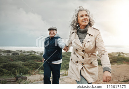 Beach, love and senior couple holding hands on romantic evening walk in nature on happy date. Smile, romance and retirement, old woman and man walking on ocean path at sunset on holiday in Australia. Beach, love and senior couple holding hands on romantic evening walk in nature on happy date. Smile, romance and retirement, old woman and man walking on ocean path at sunset on holiday in Australia. 133017875