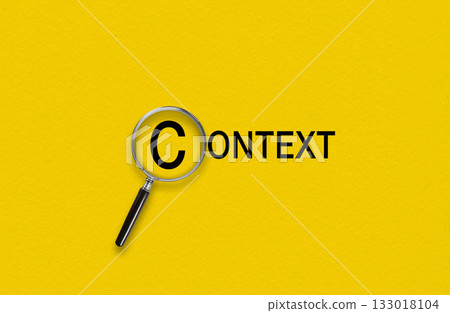 Magnifying glass focusing on the word Context. Contextual advertising concept Magnifying glass focusing on the word Context. Contextual advertising concept 133018104