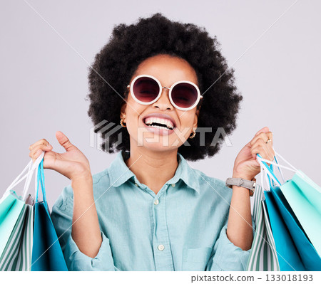 Shopping bag, retail glasses and happy black woman with luxury sales product, designer fashion deal or mall store present. Commerce market, discount gift and studio customer face on gray background Shopping bag, retail glasses and happy black woman with luxury sales product, designer fashion deal or mall store present. Commerce market, discount gift and studio customer face on gray background 133018193