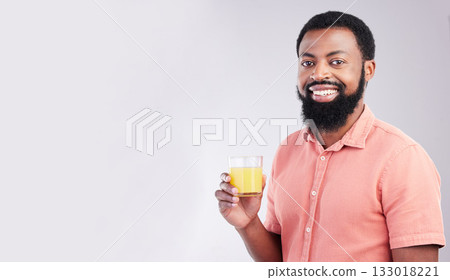 Orange juice, studio portrait and happy black man with drink glass for hydration, liquid detox or weight loss beverage. Vitamin C benefits, male nutritionist diet or person on mockup gray background 133018221