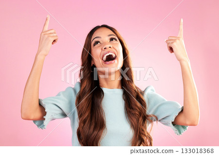 Pointing, mockup and woman on pink background with happy, smile and excited for sale, deal or discount news. Advertising, hands and girl looking up for product placement, promotion and announcement 133018368