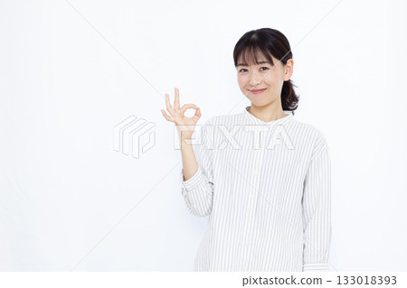 一名女子微笑並做出“OK”手勢 133018393