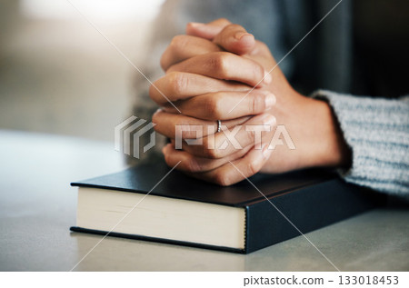 Bible book, person or hands praying for hope, help or support in Christianity religion or holy faith on table. Believe, prayer or woman studying or worshipping God in spiritual literature at home 133018453