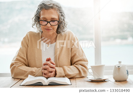 Bible, reading book or senior woman in prayer for holy worship, support or hope in Christianity or faith. Praying, tea or catholic elderly person studying or learning God in spiritual religion alone 133018490