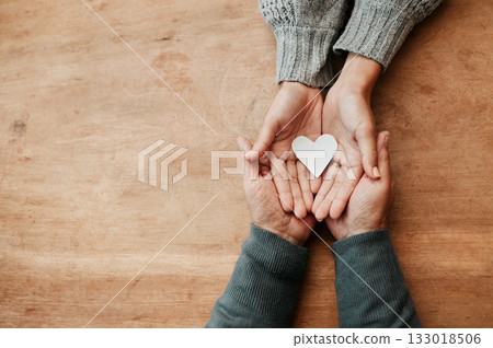 Hands, heart and shape for love, support or care above in trust, unity or compassion together on mockup table. Top view of hand holding for family generation, hope or symbol in bonding relationship 133018506