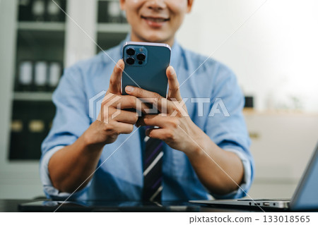 Businessman hand using smart phone laptop and tablet with social network diagram on desk as concept Businessman hand using smart phone laptop and tablet with social network diagram on desk as concept 133018565