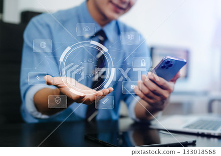 Young professional using smartphone with digital circuit UI hologram. Concept of AI, cybersecurity, innovation, Young professional using smartphone with digital circuit UI hologram. Concept of AI, cybersecurity, innovation, 133018568