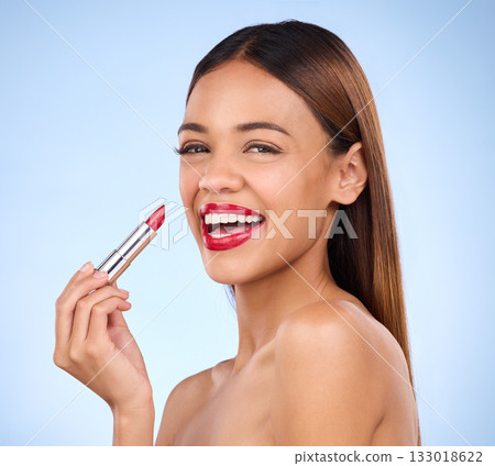 Beauty, woman and red lipstick or makeup portrait for face cosmetics in studio. Aesthetic female model on a blue background for self care, facial glow and color application for lips with a smile 133018622