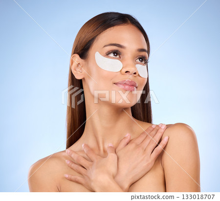 Skincare, collagen and woman with eye mask for anti aging beauty routine on blue background mockup. Cosmetics, facial repair and face of hispanic model with detox treatment product in studio promo. Skincare, collagen and woman with eye mask for anti aging beauty routine on blue background mockup. Cosmetics, facial repair and face of hispanic model with detox treatment product in studio promo. 133018707