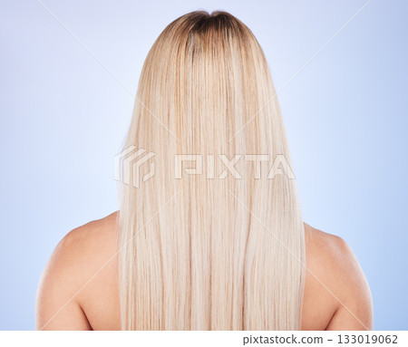 Hair care, beauty and back of woman in studio isolated on a blue background. Haircare, keratin cosmetics and female model with blonde hairstyle after salon treatment for growth, texture or balayage. 133019062