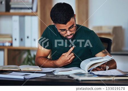Student, black man and books to study on home desk thinking, reading and studying for college. Person learning and focused on information on page for education, knowledge and working on law research Student, black man and books to study on home desk thinking, reading and studying for college. Person learning and focused on information on page for education, knowledge and working on law research 133019178