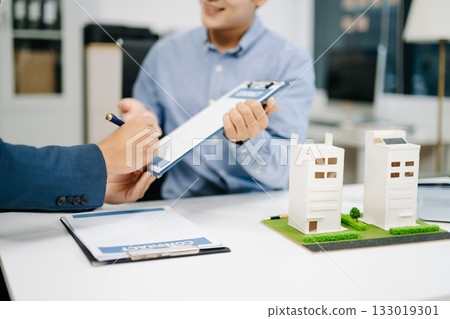 Real estate broker consults with customer signing contract agreement at office. Business deal, insurance decision 133019301