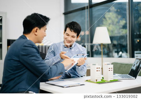 Real estate broker consults with customer signing contract agreement at office. Business deal, insurance decision Real estate broker consults with customer signing contract agreement at office. Business deal, insurance decision 133019302