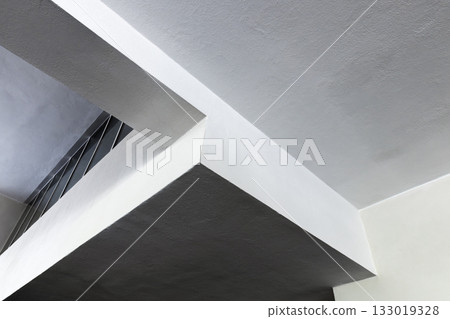 A striking interior scene featuring concrete girders and bold intersecting planes 133019328