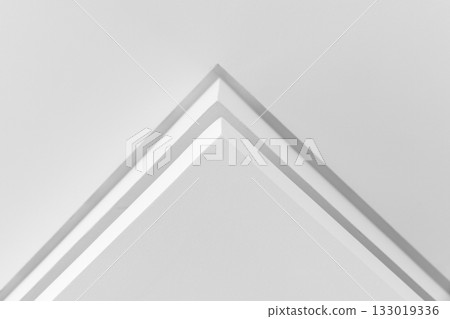 A close-up of a white architectural corner forming a sharp pyramid. Abstract interior A close-up of a white architectural corner forming a sharp pyramid. Abstract interior 133019336
