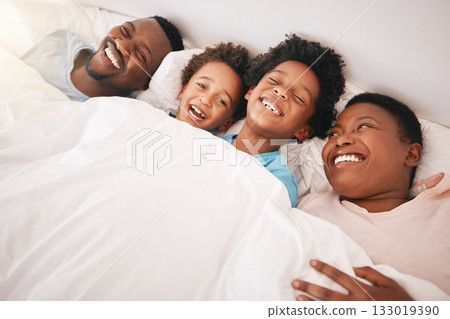 Funny, happy and relax with black family in bedroom for bonding, wake up and morning routine from top view. Smile, laugh and cute with parents and children at home for calm, weekend and quality time Funny, happy and relax with black family in bedroom for bonding, wake up and morning routine from top view. Smile, laugh and cute with parents and children at home for calm, weekend and quality time 133019390