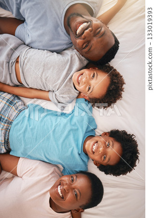 Happy black family, bed portrait and top view with happiness, kids and together with dad, mom and love. African children smile, parents and bedroom for bonding, care or support in morning for holiday Happy black family, bed portrait and top view with happiness, kids and together with dad, mom and love. African children smile, parents and bedroom for bonding, care or support in morning for holiday 133019393