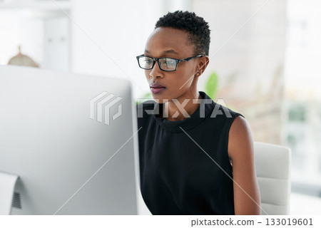 Business, computer and serious black woman in office for research, planning or concentration. Focus, mindset and African female copywriter online for creative idea inspiration on blurred background 133019601