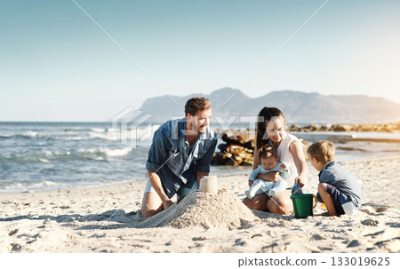 Sandcastle, happy summer and children at the beach with bonding, love and support. Baby, mom and dad together with kids playing in the sun with mockup space and smile by the ocean and sea with family 133019625