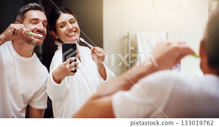 Selfie, brushing teeth and couple in a bathroom, mirror and happiness with hygiene, home and wellness. Partners, man or woman with a smile, social media or mouth cleaning with reflection or self care Selfie, brushing teeth and couple in a bathroom, mirror and happiness with hygiene, home and wellness. Partners, man or woman with a smile, social media or mouth cleaning with reflection or self care 133019762