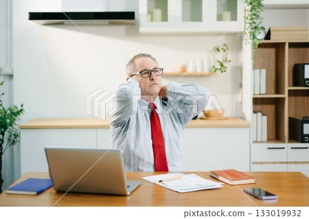 Overworked businessman office worker suffering from neck pain after had a long day at desk. office syndrome concept Overworked businessman office worker suffering from neck pain after had a long day at desk. office syndrome concept 133019932