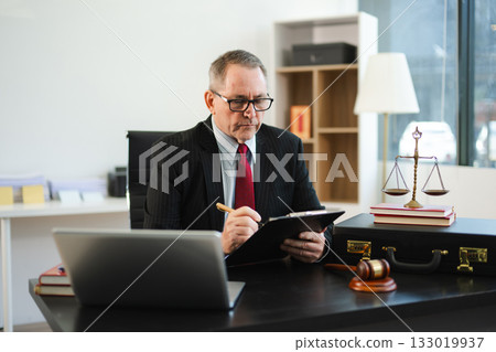 Man lawyer working and gavel, tablet, laptop in front, Advice justice and law concept. 133019937