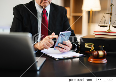 justice and law concept. Male judge in a courtroom the gavel, working with smart phone and laptop and digital tablet justice and law concept. Male judge in a courtroom the gavel, working with smart phone and laptop and digital tablet 133020008