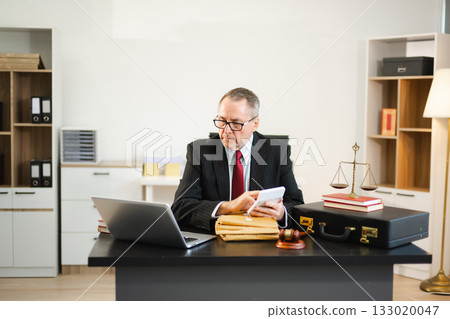 Man lawyer working and gavel, tablet, laptop in front, Advice justice and law concept. 133020047