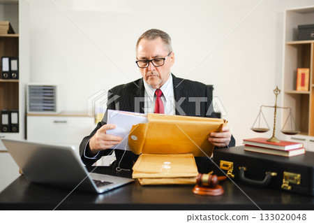 Caucasian male judge in courtroom, lawyer working in office. Perfect for business, legal advice, corporate law Caucasian male judge in courtroom, lawyer working in office. Perfect for business, legal advice, corporate law 133020048