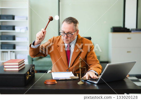 Mature Male judge in a courtroom on white table and Counselor or Male lawyer working in office. Justice and law concept 133020128