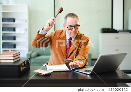 Mature Male judge in a courtroom on white table and Counselor or Male lawyer working in office. Justice and law concept 133020132