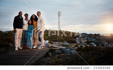 Big family, portrait walking and nature bonding on a holiday at sunset by a sea lighthouse. Ocean, beach walk and outdoor with a mom, father and child together with love and parents support at dusk 133020160