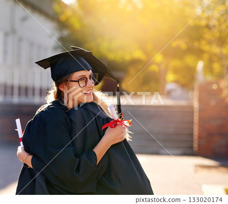 Women, students and hug at graduation as college or university friends with achievement. Happy people outdoor to celebrate education goals, certificate of success or future at school event with pride Women, students and hug at graduation as college or university friends with achievement. Happy people outdoor to celebrate education goals, certificate of success or future at school event with pride 133020174