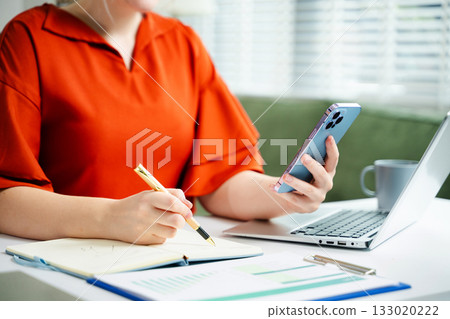 businesswoman hand writing on the notepad with new modern computer strategy diagram as concept businesswoman hand writing on the notepad with new modern computer strategy diagram as concept 133020222