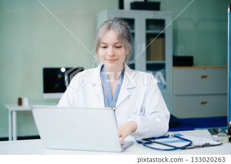 Medical technology concept. Doctor working with mobile phone and stethoscope in modern office Medical technology concept. Doctor working with mobile phone and stethoscope in modern office 133020263
