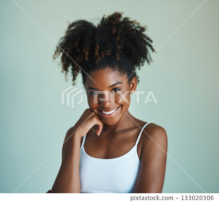 Smile, confidence and portrait of young black woman on studio background with afro, happiness and skincare. Beauty, dermatology and happy African girl, model with mockup, skin glow and beautiful face Smile, confidence and portrait of young black woman on studio background with afro, happiness and skincare. Beauty, dermatology and happy African girl, model with mockup, skin glow and beautiful face 133020306