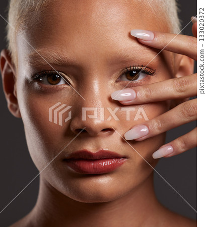 Makeup, hands on face and portrait of woman in studio for beauty products, cosmetics and skincare. Salon aesthetic, cosmetology and zoom of girl with manicure, self love and luxury on gray background 133020372