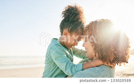 Family, mother and kid hug at beach, travel and summer with sunshine lens flare and together outdoor. Trust, support with woman and girl smile on vacation, love and care in nature with happiness 133020589