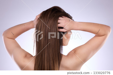 Back, beauty and hair care of woman in studio isolated on a gray background. Texture, cosmetics and young female model with salon treatment for healthy keratin, balayage and natural hairstyle growth. Back, beauty and hair care of woman in studio isolated on a gray background. Texture, cosmetics and young female model with salon treatment for healthy keratin, balayage and natural hairstyle growth. 133020776