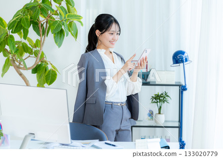 操作智能手機的女商人 133020779