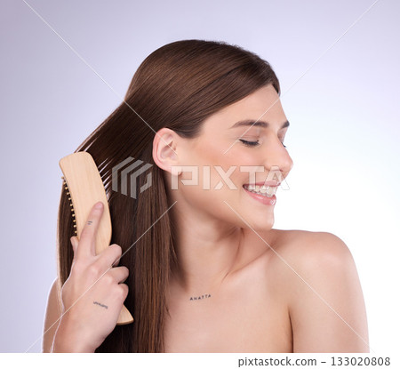 Hair care, beauty smile and woman with brush in studio isolated on a gray background. Cosmetics, keratin and happy female model with sustainable wooden hairbrush for salon treatment and hairstyle. Hair care, beauty smile and woman with brush in studio isolated on a gray background. Cosmetics, keratin and happy female model with sustainable wooden hairbrush for salon treatment and hairstyle. 133020808