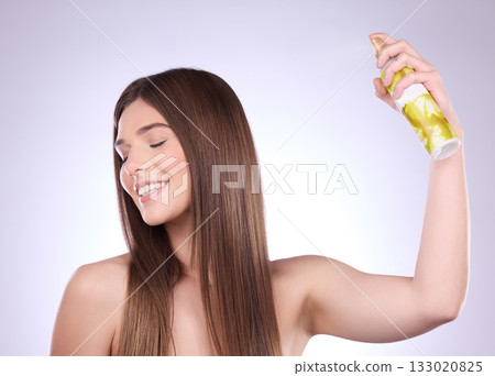 Beauty smile, hair care and woman with spray in studio isolated on a gray background. Cosmetics, eyes closed and happy female model with hairspray product for salon treatment, growth and hairstyle. Beauty smile, hair care and woman with spray in studio isolated on a gray background. Cosmetics, eyes closed and happy female model with hairspray product for salon treatment, growth and hairstyle. 133020825
