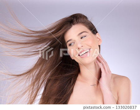 Beauty, hair and breeze with a model woman in studio on a gray background for haircare or keratin treatment. Shampoo, salon and natural with an attractive young female posing in a wind on a wall 133020837
