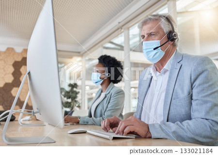 Covid, help desk employees with mask at computer and mature man and black woman in call center. Office compliance, consulting team online in coworking space and medical advisory agency with diversity 133021184